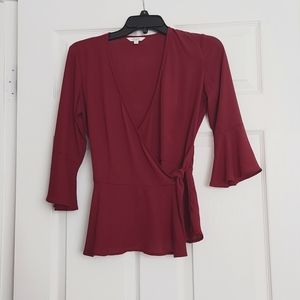 CANDIES Burgundy wrap blouse with flare arm and bottom.